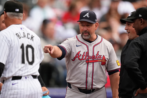 FILE - Atlanta Braves bench coach Walt Weiss, right, points to Colorado Rockies manager Bud Black before the first inning of a baseball game Aug. 9, 2024, in Denver. (AP Photo/David Zalubowski, File)