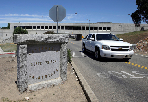 FILE - A vehicle drives by the main entrance to California State Prison, Sacramento, May 16, 2016, in Folsom, Calif. (AP Photo/Rich Pedroncelli, File)