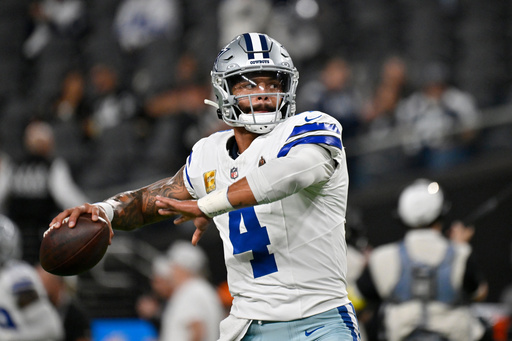 Dallas Cowboys quarterback Dak Prescott warms up prior to an NFL football game against the Las Vegas Raiders Monday, Nov. 17, 2025, in Las Vegas. (AP Photo/David Becker)