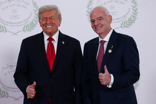 President Donald Trump and FIFA president Gianni Infantino pose for a photo in Sharm el-Sheikh, Egypt, Monday, Oct. 13, 2025. (Suzanne Plunkett, Pool Photo via AP)