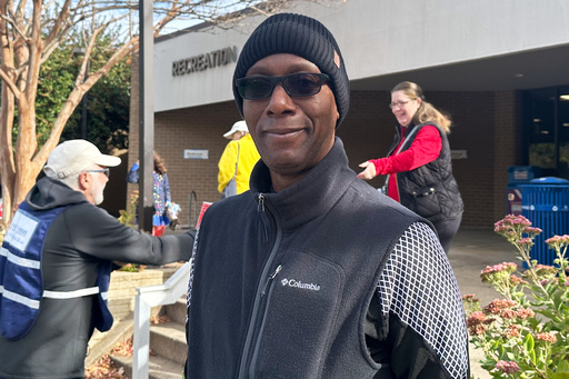 Alonzie Scott, a recently retired federal worker, is seen at an Arlington, Va., polling center on Tuesday, Nov. 4th, 2025. (AP Photo/Helen Wieffering)