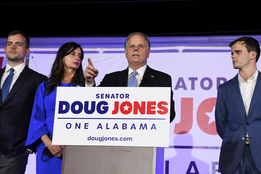 FILE - Sen. Doug Jones delivers his concession speech surrounded by family during his election night watch party, Nov. 3, 2020, in Birmingham, Ala. (AP Photo/Julie Bennett, File)
