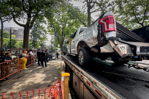 FILE - New York City authorities work a crime scene of a deadly crash Friday, July 5, 2024, in the Lower East Side neighborhood in New York. (AP Photo/John Minchillo, file)