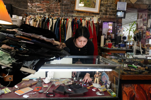 Satani Silva works at Pilsen Vintage, Wednesday, Nov. 19, 2025, in the Pilsen neighborhood of Chicago. (AP Photo/Erin Hooley)