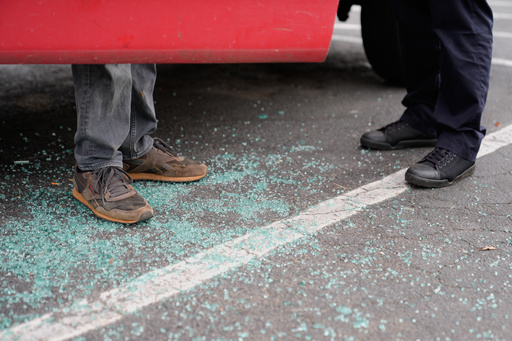Willy Aceituno, left, makes a police report with Charlotte-Mecklenburg Police Department officer N. Sherill, after U.S. Customs and Border Protection officers broke his window during an enforcement operation, Saturday, Nov. 15, 2025, in Charlotte, N.C. (AP Photo/Erik Verduzco)