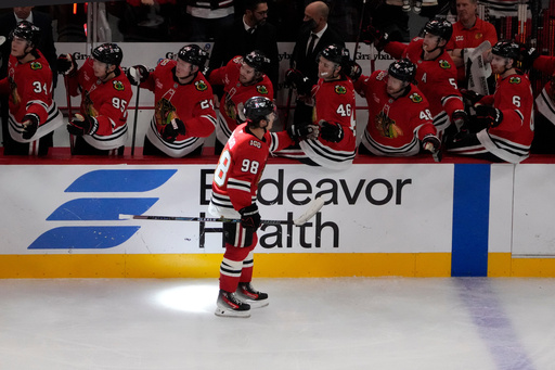Chicago Blackhawks center Connor Bedard (98) celebrates his goal against the Calgary Flames during the third period of an NHL hockey game Tuesday, Nov. 18, 2025, in Chicago. (AP Photo/David Banks)