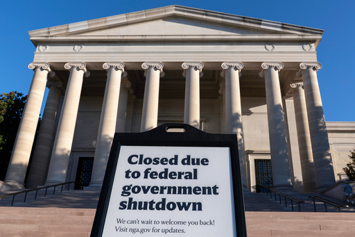 FILE - A sign that reads "Closed due to federal government shutdown," is seen outside of the National Gallery of Art in Washington, Oct. 6, 2025. (AP Photo/Jose Luis Magana, File)