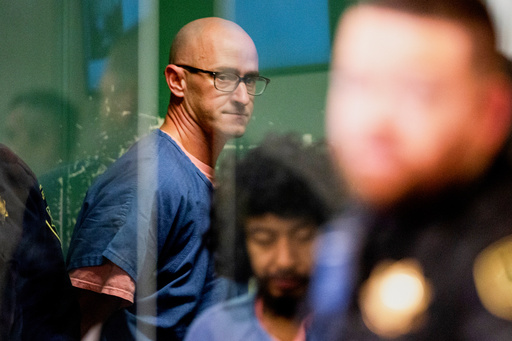 FILE - Joseph David Emerson, back, appears in Multnomah County Circuit Court for an indictment hearing in Portland, Ore., on Dec. 7, 2023. (Dave Killen/The Oregonian via AP, Pool, File)