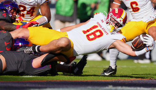 Iowa State tight end Benjamin Brahmer (18) scores a touchdown against TCU defenders Vernon Glover (26), Jamel Johnson (2) and Devean Deal (11) during the first half of an NCAA college football game Saturday, Nov. 8, 2025, in Fort Worth, Texas. (AP Photo/LM Otero)