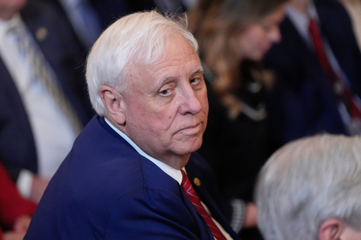 FILE - Sen. Jim Justice, R-W.Va., listens as President Donald Trump speaks during an event on energy production in the East Room of the White House, April 8, 2025, in Washington. (AP Photo/Alex Brandon, File)
