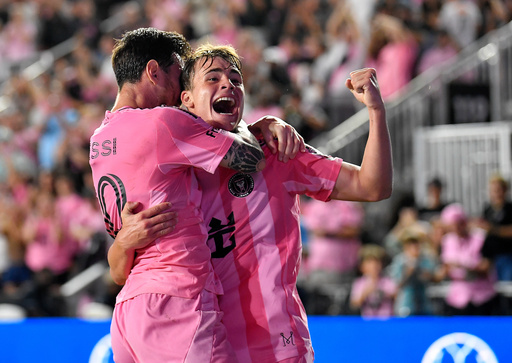 Inter Miami forward Lionel Messi, left, celebrates with forward Mateo Silvetti, right, after scoring during the first half of Game 3 in the first round of MLS soccer's Western Conference playoffs against Nashville SC in Fort Lauderdale, Fla., Nov. 8, 2025. (AP Photo/Michael Laughlin)