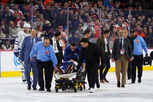 Toronto Maple Leafs' Chris Tanev is taken off the ice on a stretcher by medical staff after a collision during the third period of an NHL hockey game against the Philadelphia Flyers, Saturday, Nov. 1, 2025, in Philadelphia. (AP Photo/Derik Hamilton)