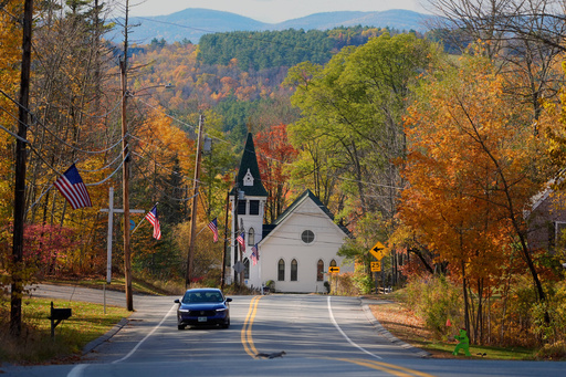Fall foliage colors the scene near the Community Church, Tuesday, Oct. 21, 2025, in Sugar Hill, N.H., a rural area where the closure of a community health center is leaving residents without nearby medical care. (AP Photo/Robert F. Bukaty)
