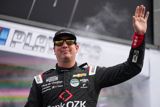 Kyle Busch waves to fans prior to a NASCAR Cup Series auto race at Charlotte Motor Speedway, Sunday, Oct. 5, 2025, in Concord, N.C. (AP Photo/Matt Kelley)