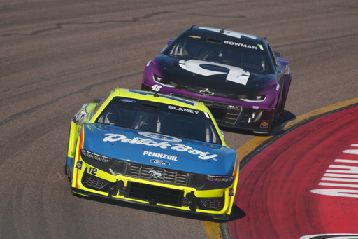 Ryan Blaney (12) leads Alex Bowman into the corner during a NASCAR Cup Series auto race Sunday, Nov. 2, 2025, in Avondale, Ariz. (AP Photo/Rick Scuteri)