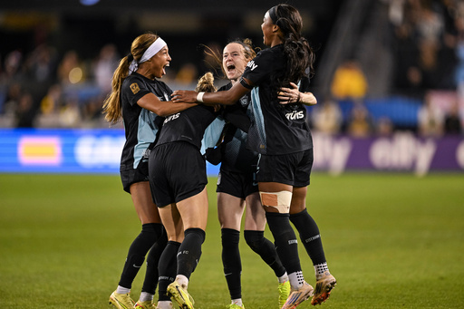 NJ/NY Gotham FC midfielder Rose Lavelle (16) is mobbed by her teammates after scoring a goal to take the lead during the second half of a NWSL women's championship soccer match against the Washington Spirit, Saturday, Nov. 22, 2025, in San Jose, Calif. (AP Photo/Justine Willard)