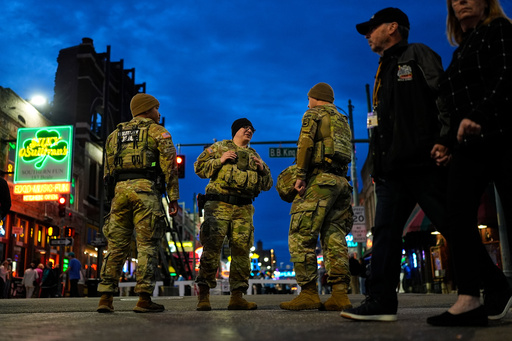 Members of the National Guard stand watch at the intersection of B.B. King Blvd. and Beale Street, Friday, Oct. 24, 2025, in Memphis, Tenn. (AP Photo/George Walker IV)