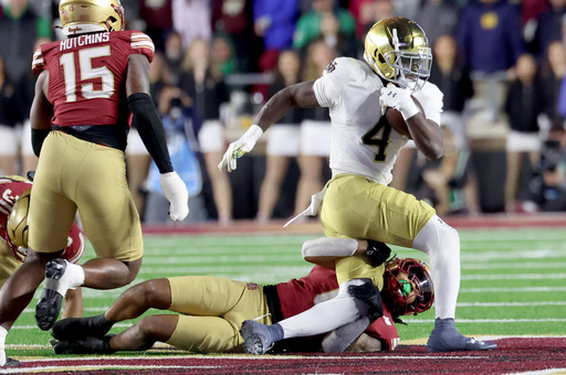 Boston College defensive back Omar Thornton (0) tackles Notre Dame running back Jeremiyah Love (4) during the second half of an NCAA college football game Saturday, Nov. 1, 2025, in Boston. (AP Photo/Mark Stockwell)