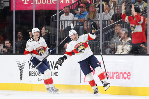 Florida Panthers center Eetu Luostarinen (27) and left wing Brad Marchand (63) celebrate after Marchand's goal against the Vegas Golden Knights during the second period of an NHL hockey game Monday, Nov. 10, 2025, in Las Vegas. (AP Photo/Ian Maule)