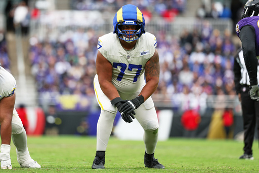 FILE - Los Angeles Rams offensive tackle Alaric Jackson (77) gets in position during the first half of an NFL football game against the Baltimore Ravens, Oct. 12, 2025, in Baltimore. (AP Photo/Terrance Williams, File)