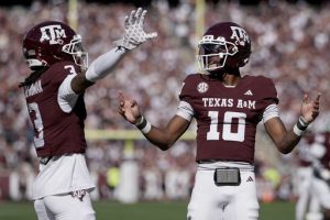 Texas A&M wide receiver Ashton Bethel-Roman (3) reacts with quarterback Marcel Reed (10) after scoring a touchdown agianst Samford during the first quarter of an NCAA college football game Saturday, Nov. 22, 2025, in College Station, Texas. (AP Photo/Sam Craft)