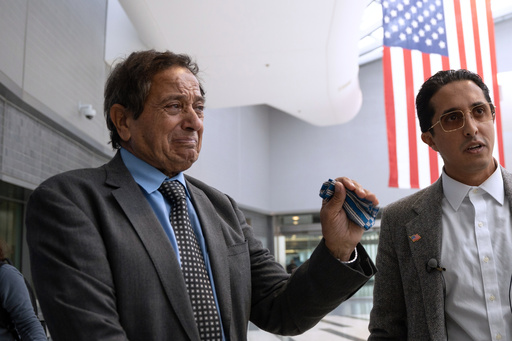 Father-son duo Saad and Ibrahim Almadi speak to reporters after entering the Philadelphia International Airport International Arrivals Hall on Thursday, Nov. 20, 2025, in Philadelphia. (AP Photo/Mingson Lau)
