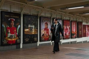 A person walks past posters promoting the campaign by Bath & Body Works at Grand Central station, Wednesday, Nov. 19, 2025, in New York. (AP Photo/Yuki Iwamura)