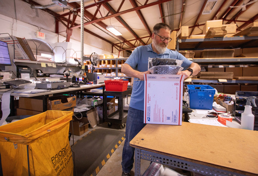 FILE - Terry Precision Cycling warehouse manager Luke Tremble packs orders at the company’s warehouse in Burlington, Vt., Tuesday, Oct. 28, 2025. (AP Photo/Amanda Swinhart, File)