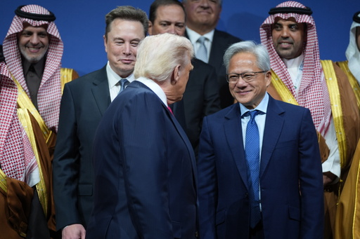 President Donald Trump speaks with Elon Musk and Nvidia CEO Jensen Huang, during the Saudi Investment Forum at the Kennedy Center, Wednesday, Nov. 19, 2025, in Washington. (AP Photo/Evan Vucci)