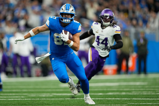 Detroit Lions tight end Sam Laporta (87) runs to score a touchdown during the first half of an NFL football game against the Minnesota Vikings Sunday, Nov. 2, 2025, in Detroit. (AP Photo/Ryan Sun)