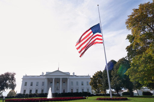 The American flag is seen at half-staff, Tuesday, Nov. 4, 2025, at the White House in Washington. (AP Photo/Manuel Balce Ceneta)